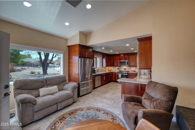 living room with vaulted ceiling, a textured ceiling, visible vents, and recessed lighting