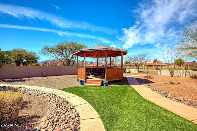 view of yard featuring a deck, a gazebo, a fenced backyard, and a hot tub