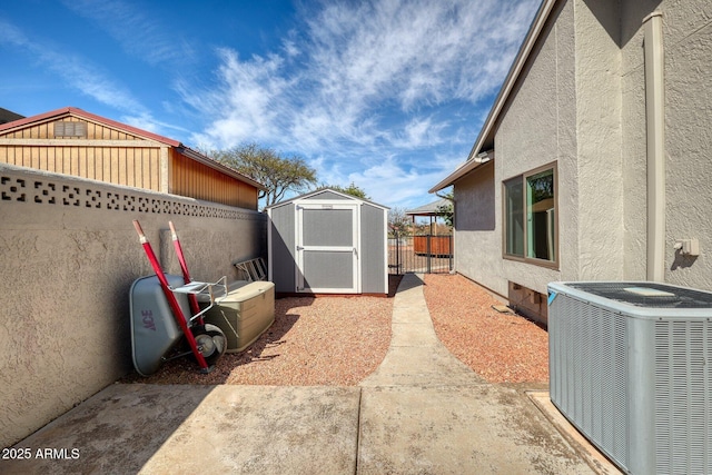 exterior space with a patio, a storage shed, central AC unit, fence, and an outdoor structure