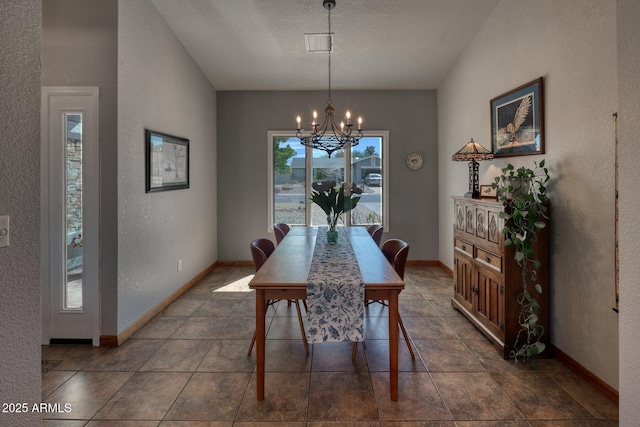 dining space featuring baseboards, a notable chandelier, and a textured wall