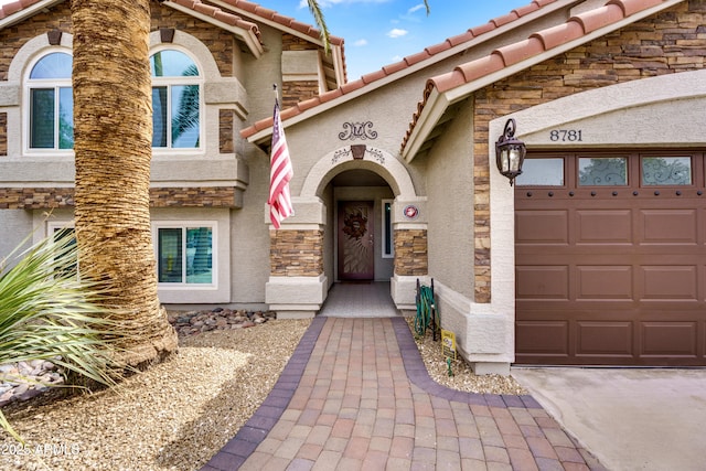 8781 S Mill Ave, Tempe, AZ 85284 - view of front of home featuring stucco siding, stone siding, an attached garage, and a tile roof