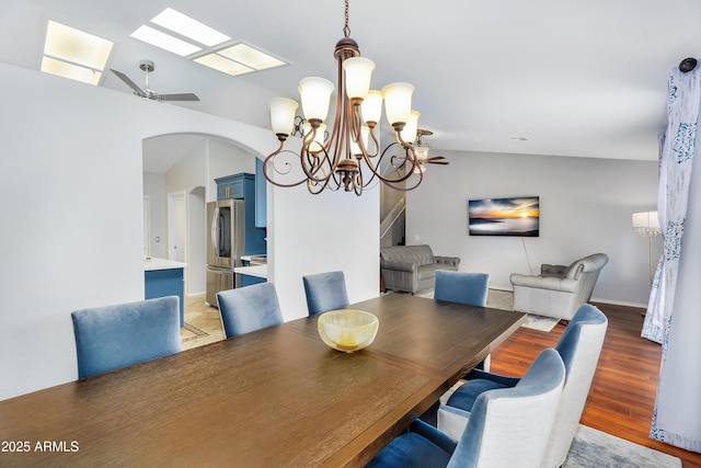 8781 S Mill Ave, Tempe, AZ 85284 - dining room with lofted ceiling, ceiling fan with notable chandelier, arched walkways, and light wood-type flooring