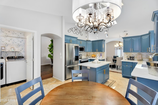 8781 S Mill Ave, Tempe, AZ 85284 - kitchen with a chandelier, independent washer and dryer, arched walkways, and stainless steel appliances