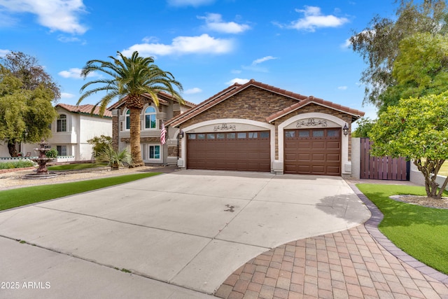 8781 S Mill Ave, Tempe, AZ 85284 - view of front of house with a tile roof, stucco siding, a garage, driveway, and a gate
