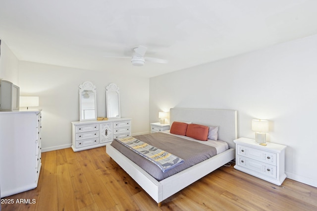 bedroom with light wood-style flooring, baseboards, and a ceiling fan