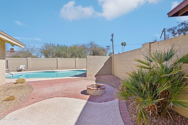 view of swimming pool featuring a patio, an outdoor fire pit, a fenced backyard, and a fenced in pool