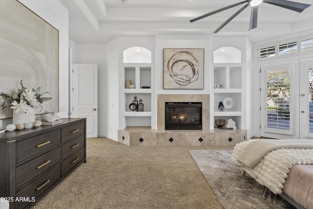 carpeted bedroom featuring ceiling fan, a premium fireplace, and access to exterior