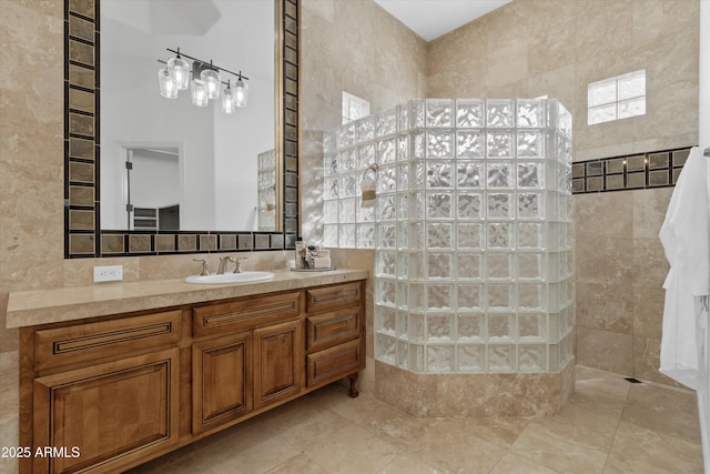 bathroom featuring tile walls, vanity, and tiled shower