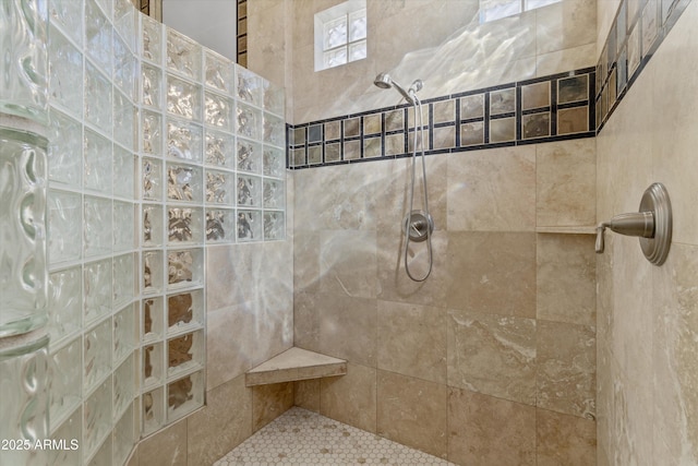 bathroom featuring a tile shower