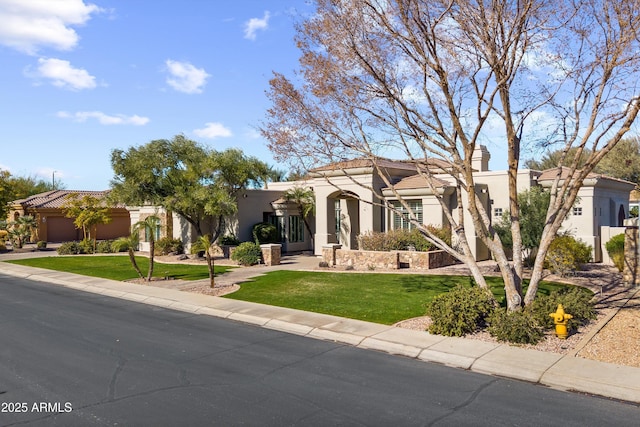 mediterranean / spanish home with a garage and a front yard