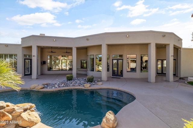 view of swimming pool with ceiling fan and a patio area