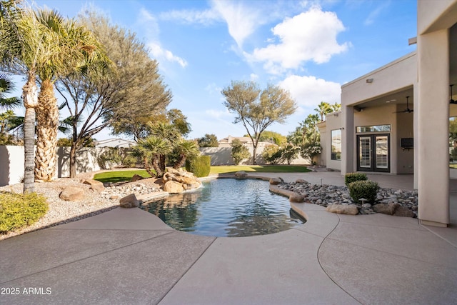 view of pool featuring french doors, ceiling fan, and a patio