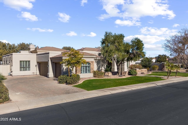 view of front of home featuring a garage and a front yard