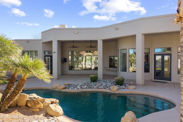 view of pool featuring a patio area, ceiling fan, and french doors