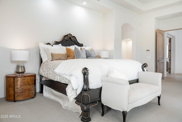 bedroom featuring carpet and arched walkways