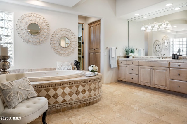 bathroom featuring tile patterned floors, a bath, and vanity