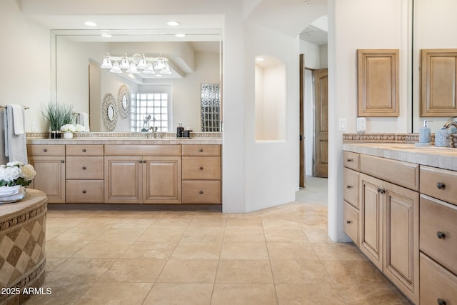 bathroom featuring a sink, recessed lighting, two vanities, and tile patterned floors