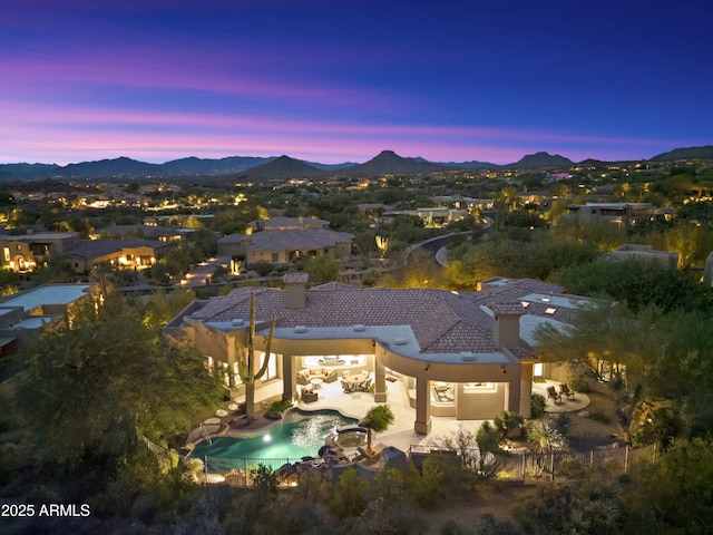 aerial view at dusk featuring a mountain view