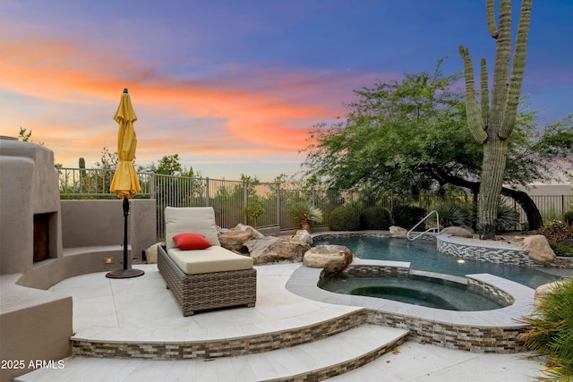 view of swimming pool with an in ground hot tub, a patio area, a fenced backyard, and a fenced in pool