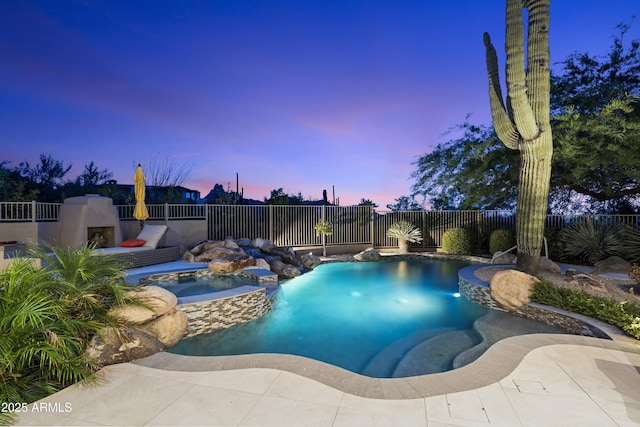 view of pool featuring an in ground hot tub, exterior fireplace, and a fenced backyard