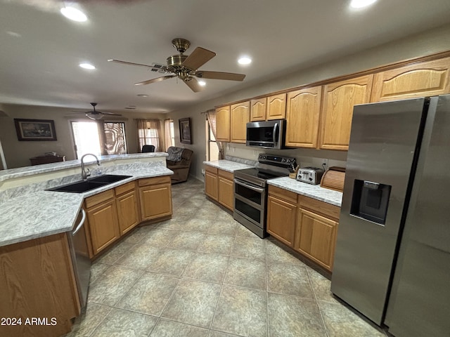 kitchen featuring sink, ceiling fan, and appliances with stainless steel finishes