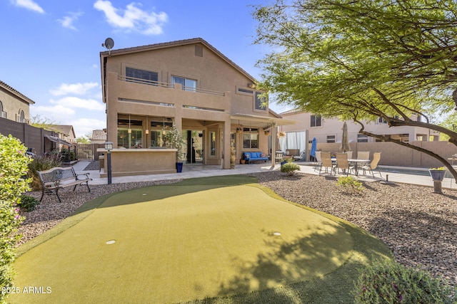 3859 N El Sereno St, Mesa, AZ 85207 - rear view of property featuring a patio area, a putting green, and stucco siding