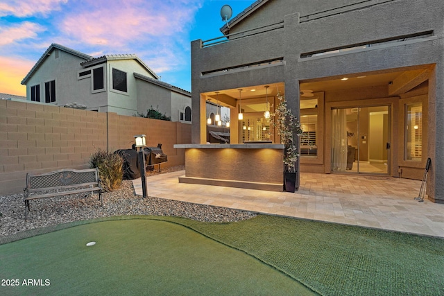 3859 N El Sereno St, Mesa, AZ 85207 - patio terrace at dusk with an area to practice putting and a patio