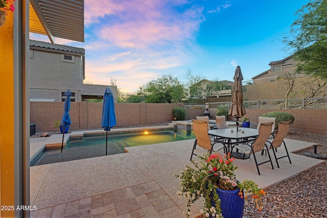 3859 N El Sereno St, Mesa, AZ 85207 - patio terrace at dusk with a patio, a fenced backyard, and outdoor dining space
