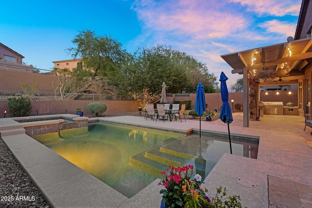 3859 N El Sereno St, Mesa, AZ 85207 - pool at dusk featuring a fenced backyard, a patio, outdoor dining area, and a pool with connected hot tub