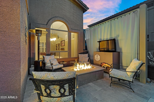 3859 N El Sereno St, Mesa, AZ 85207 - patio terrace at dusk with an outdoor fire pit and a patio