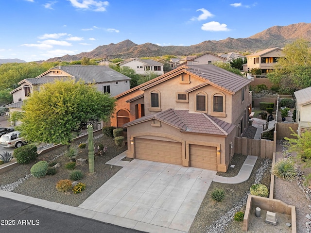 3859 N El Sereno St, Mesa, AZ 85207 - mediterranean / spanish house featuring a mountain view, stucco siding, concrete driveway, a garage, and a tile roof