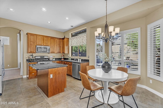 3859 N El Sereno St, Mesa, AZ 85207 - kitchen with stainless steel appliances, a center island, a chandelier, brown cabinets, and recessed lighting