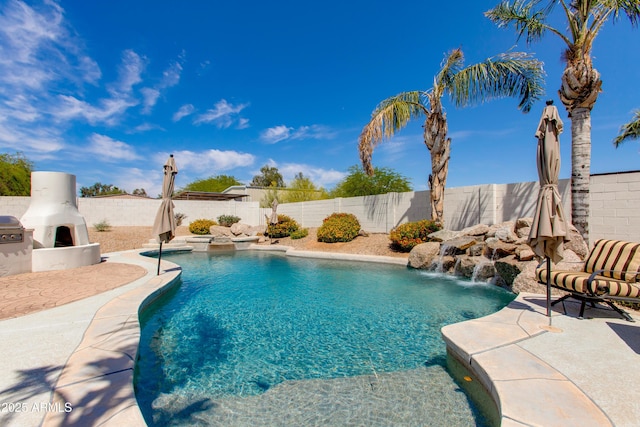 view of pool featuring a fenced backyard, a fenced in pool, an outdoor fireplace, and a patio