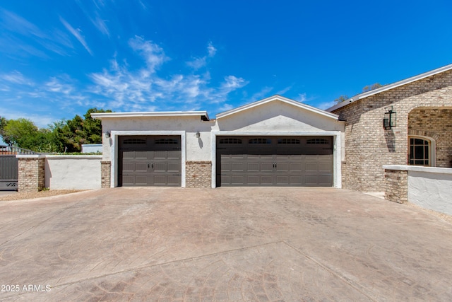 view of front facade with an attached garage, concrete driveway, and stucco siding