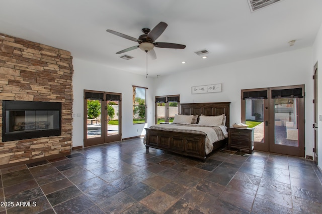 bedroom featuring visible vents, french doors, stone tile flooring, and access to exterior