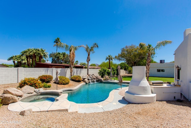 view of swimming pool featuring a fenced in pool, a fenced backyard, and an in ground hot tub