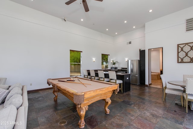 playroom featuring visible vents, billiards, a high ceiling, stone finish floor, and a ceiling fan