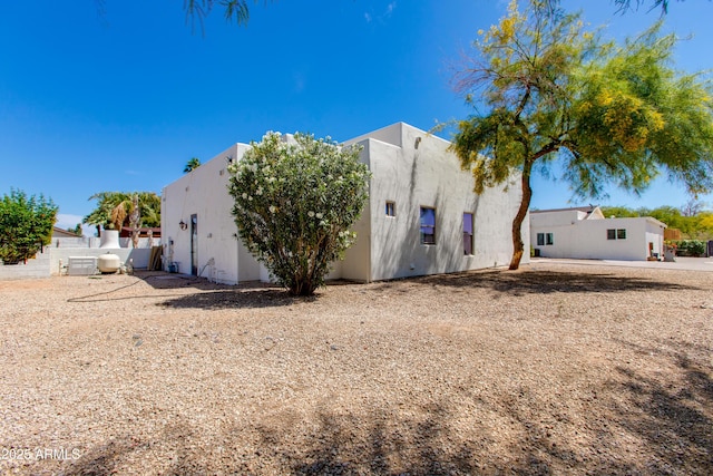 rear view of property featuring stucco siding