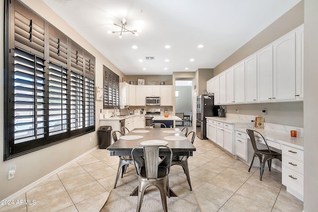 dining area featuring light tile patterned floors and a chandelier