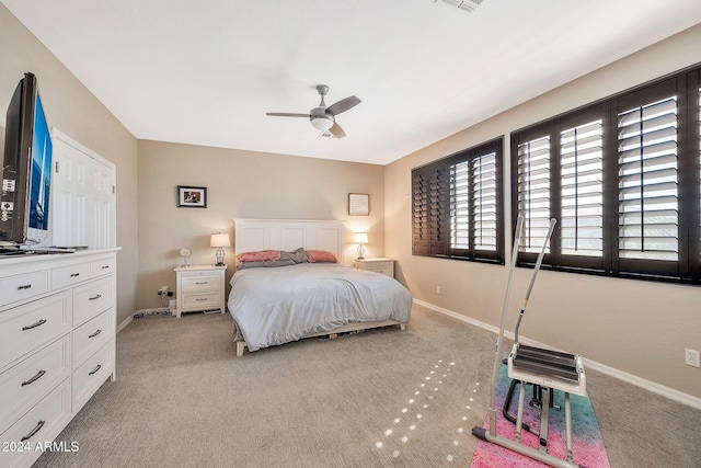 bedroom featuring light colored carpet and ceiling fan