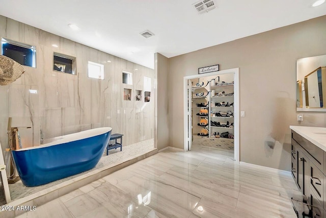 bathroom featuring vanity and shower with separate bathtub