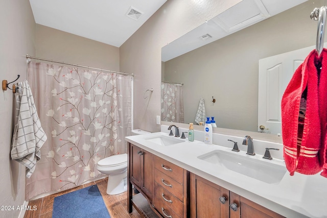 bathroom featuring vanity, hardwood / wood-style flooring, and toilet