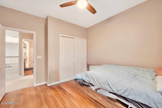 bedroom featuring wood-type flooring, a closet, and ceiling fan