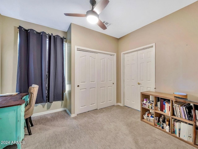 interior space with light colored carpet and ceiling fan