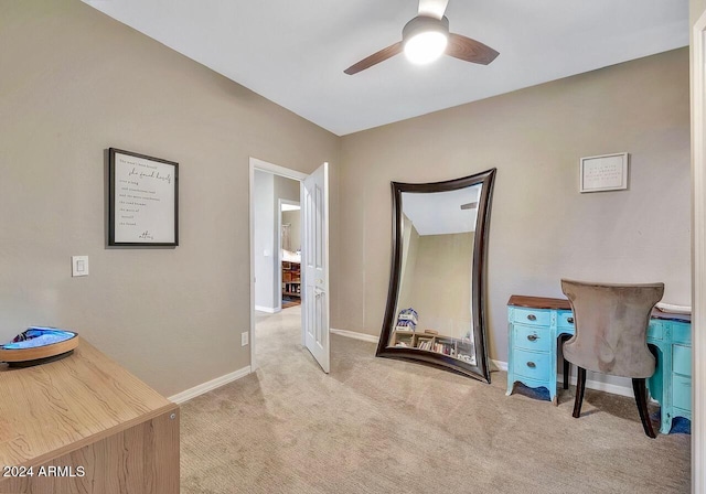 carpeted home office featuring ceiling fan