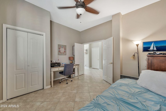 bedroom with ceiling fan, a closet, and light tile patterned floors