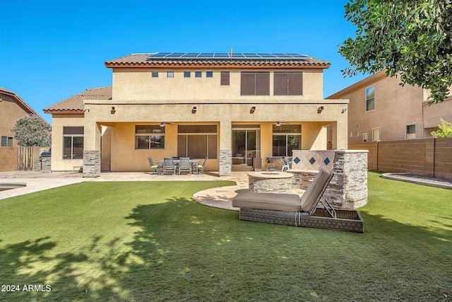 back of property with a yard and a patio