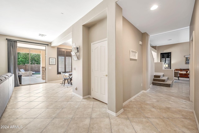 hall featuring light tile patterned floors