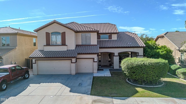 view of front of property featuring a front lawn and a garage