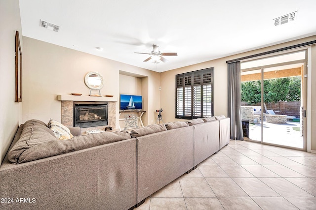 living room featuring ceiling fan and light tile patterned floors